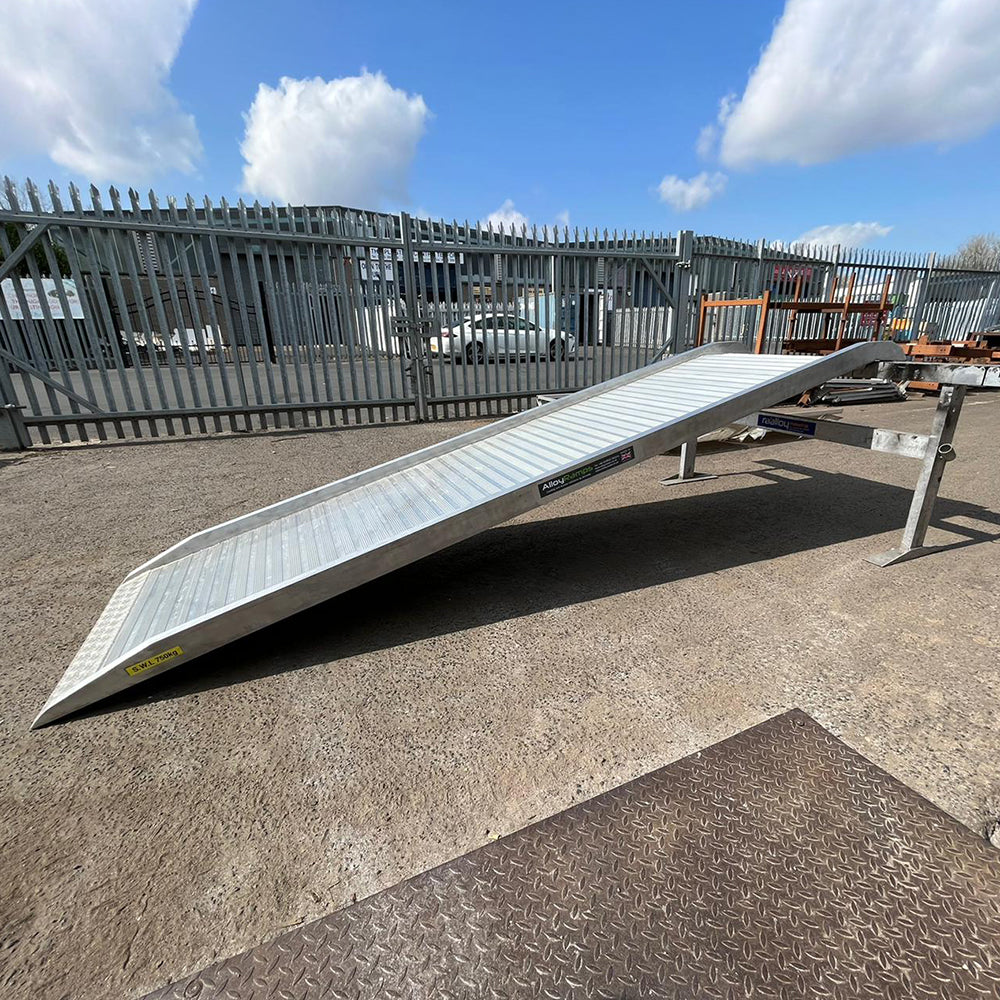 Picture of a truck loading ramp. Truck loading ramp resting against a ramp holder. Truck ramps.